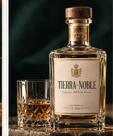 Concept heavy glass Tierra Noble bottle with cream label beside one small tasting glass against a dark green background.