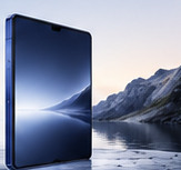 Phone resting visually before a cold mountainous blue landscape.